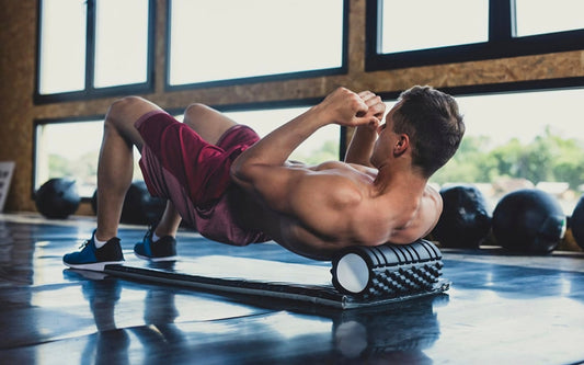 Person stretching and foam rolling after a night workout to improve muscle recovery and sleep