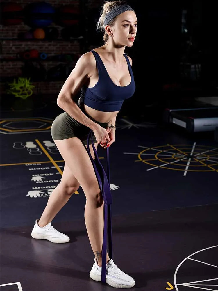 Woman training with latex resistance bands at home