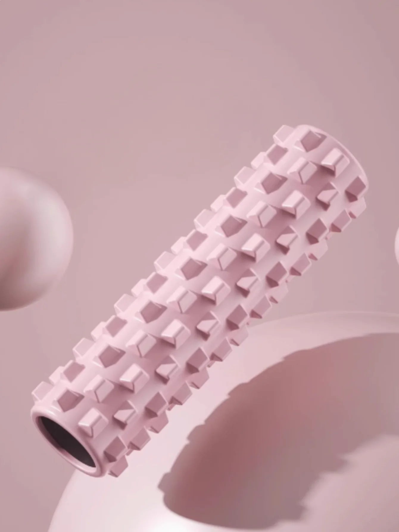 Pink yoga foam roller with matching yoga block and massage column for home workouts