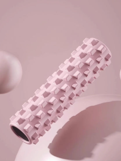 Pink yoga foam roller with matching yoga block and massage column for home workouts