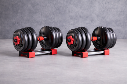 Adjustable black and red dumbbell set on a grounded gray background, fitness weight set for home workouts.