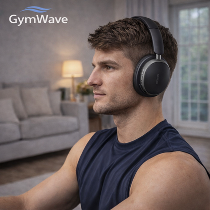 Man wearing GymWave wireless headphones while relaxing at home in a modern living room.