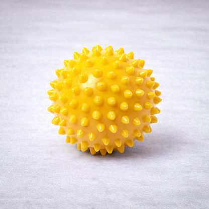 Yellow spiked massage ball to be used for massage and physiotherapy