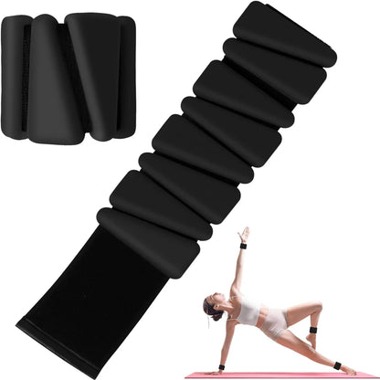 Woman performing pilates with wrist and ankle weights