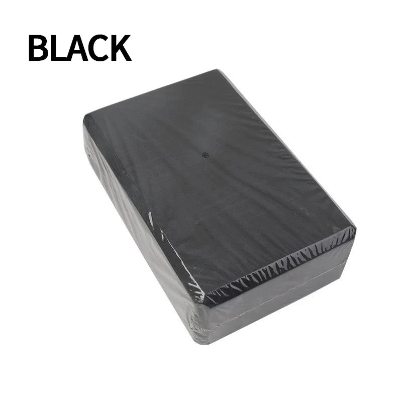 Black yoga blocks assisting in strength training exercises