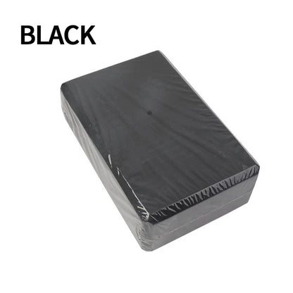 Black yoga blocks assisting in strength training exercises